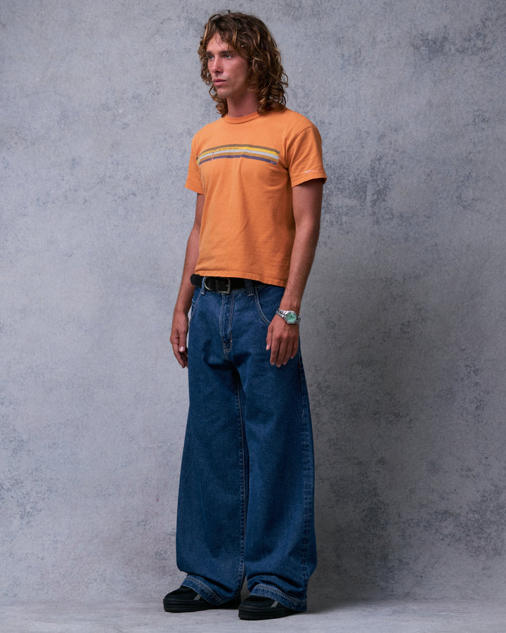 Model wearing dark stone wash wide-leg jeans, three-quarter front view