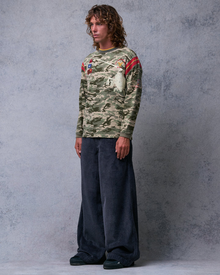 Model wearing wide-leg charcoal grey corduroy pants, three-quarter front view showing the leg width