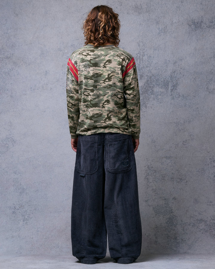 Model wearing wide-leg charcoal grey corduroy pants, back view showing large back pockets and J embroidery