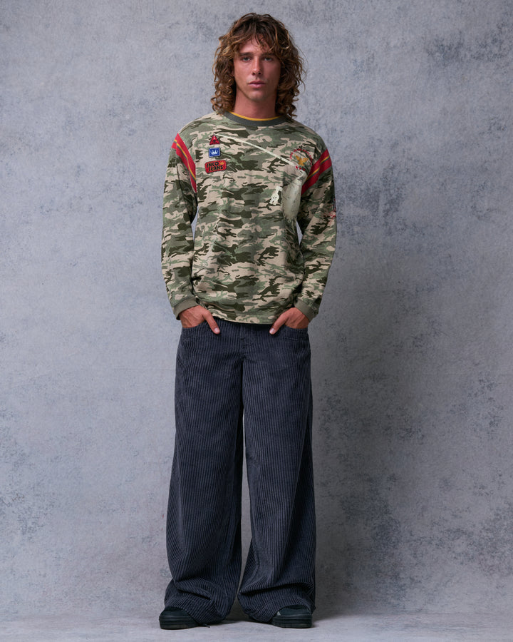 Model wearing wide-leg charcoal grey corduroy pants with hands in the front pockets, front view