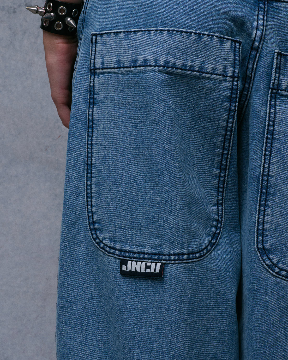 Close-up of a back pocket with dark contrast stitching and a black JNCO tab below it