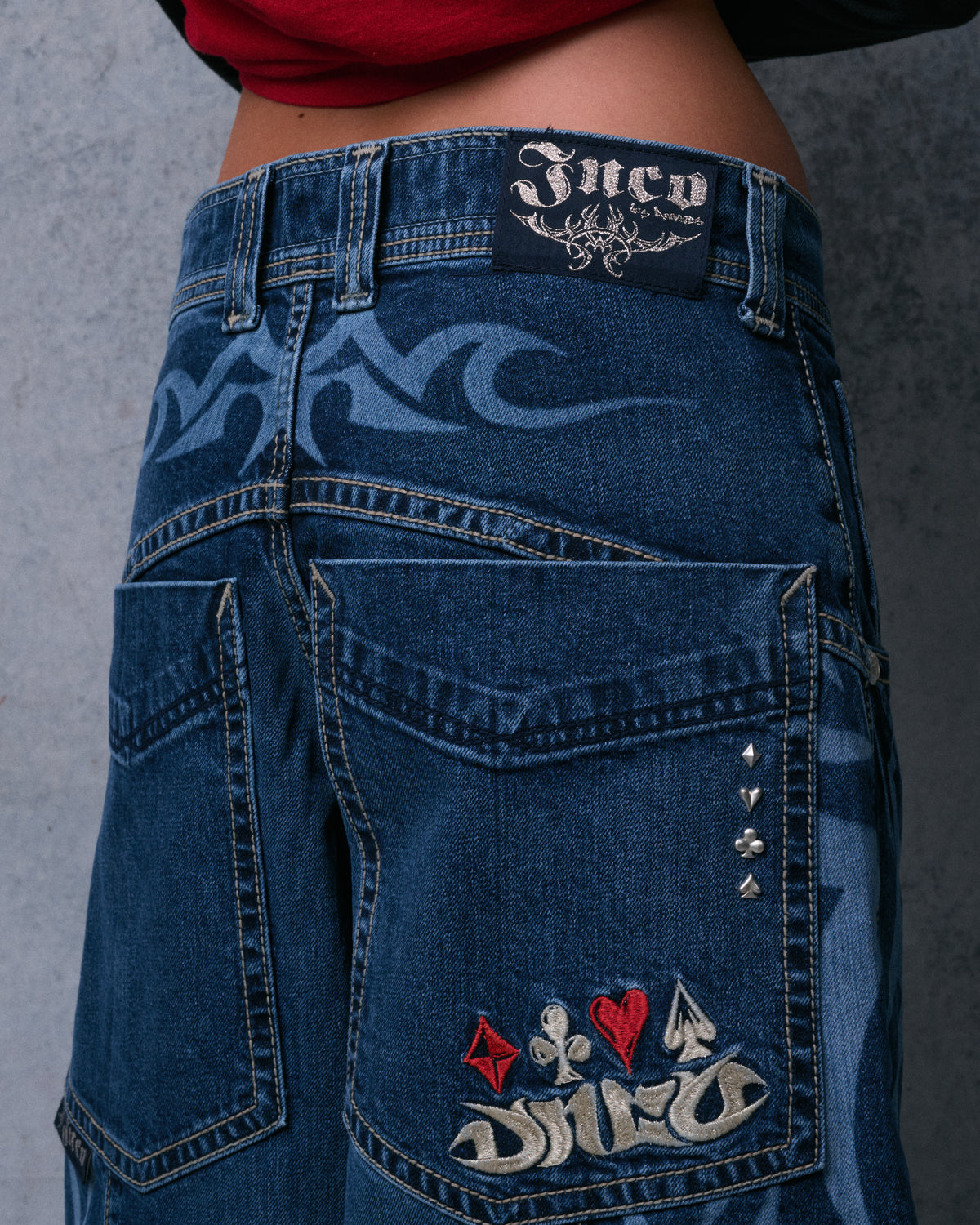 Rear view of the waistband with a JNCO leather-look patch, tribal etching and embroidered oversized back pocket