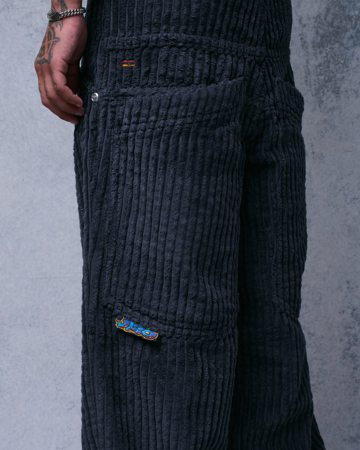 Close-up of the corduroy pants' side, showing the utility pocket with a small JNCO embroidered tab
