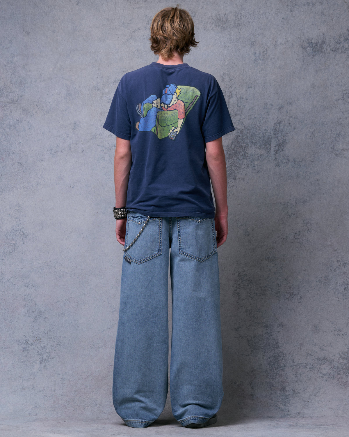 Model wearing light blue wide-leg jeans, full back view showing both back pockets and wide hems
