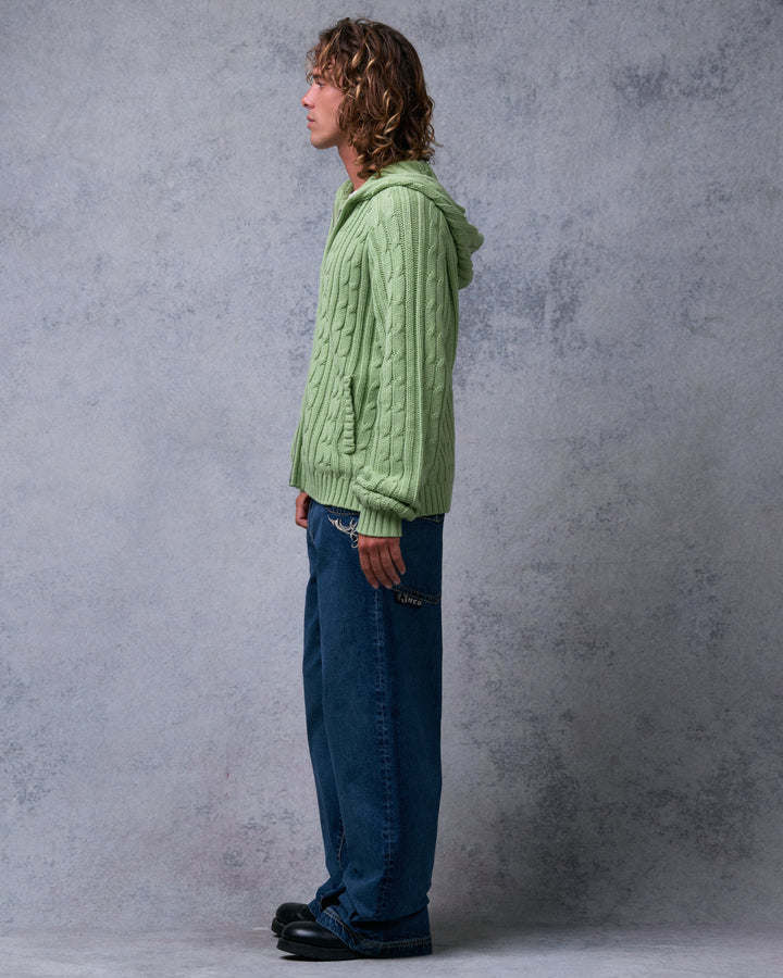 Model wearing dark stone wash wide-leg jeans, side view showing the embroidered side pocket and leg width