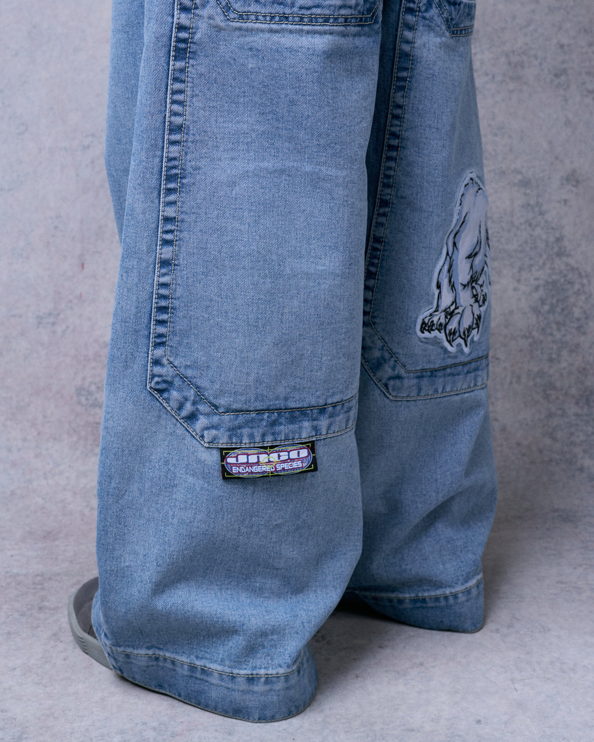 Close-up of the lower legs showing the polar bear patch and a JNCO Endangered Species label below a back pocket